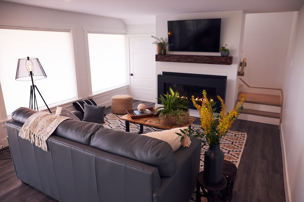 cozy downstairs family room with wood fireplace mantel