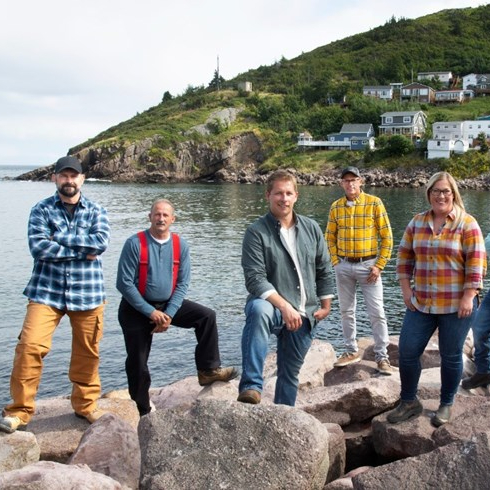 The cast of Rock Solid Builds standing on rocks