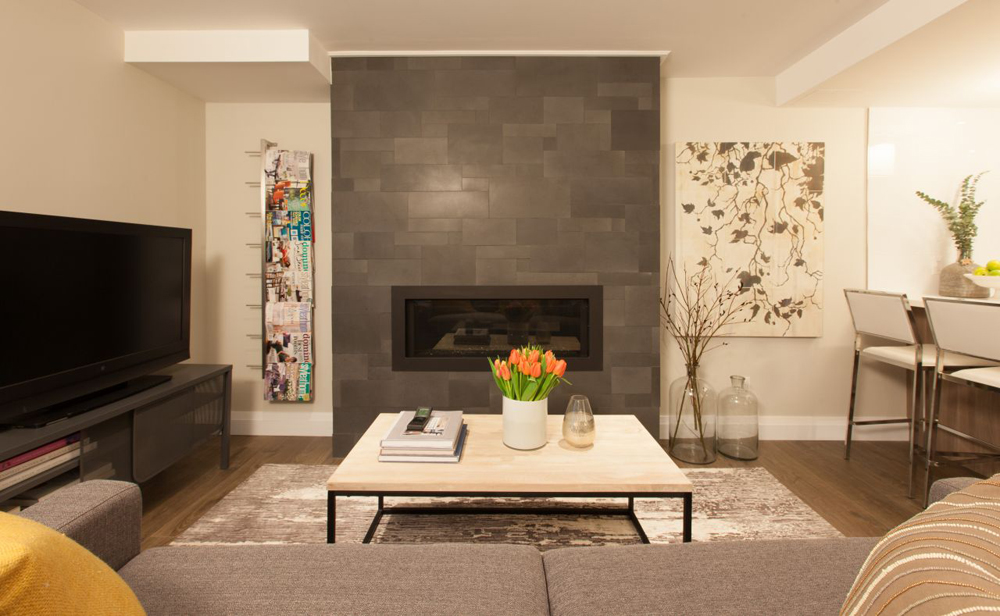 A fireplace featured in a bright living room.