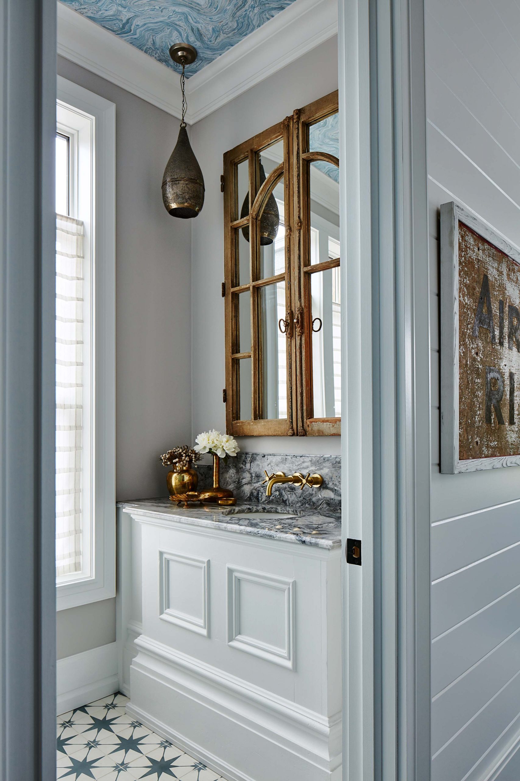 A small powder room feels like a jewel box thanks to pretty star-inspired tiling.