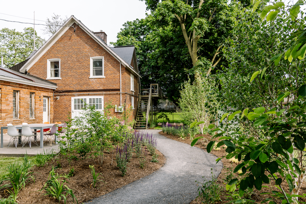 exterior of brick carriage house with landscaped yard