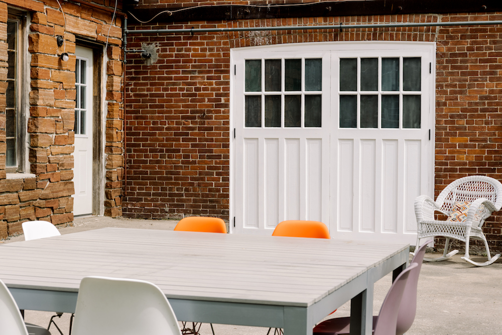 white carriage-house doors on brick building