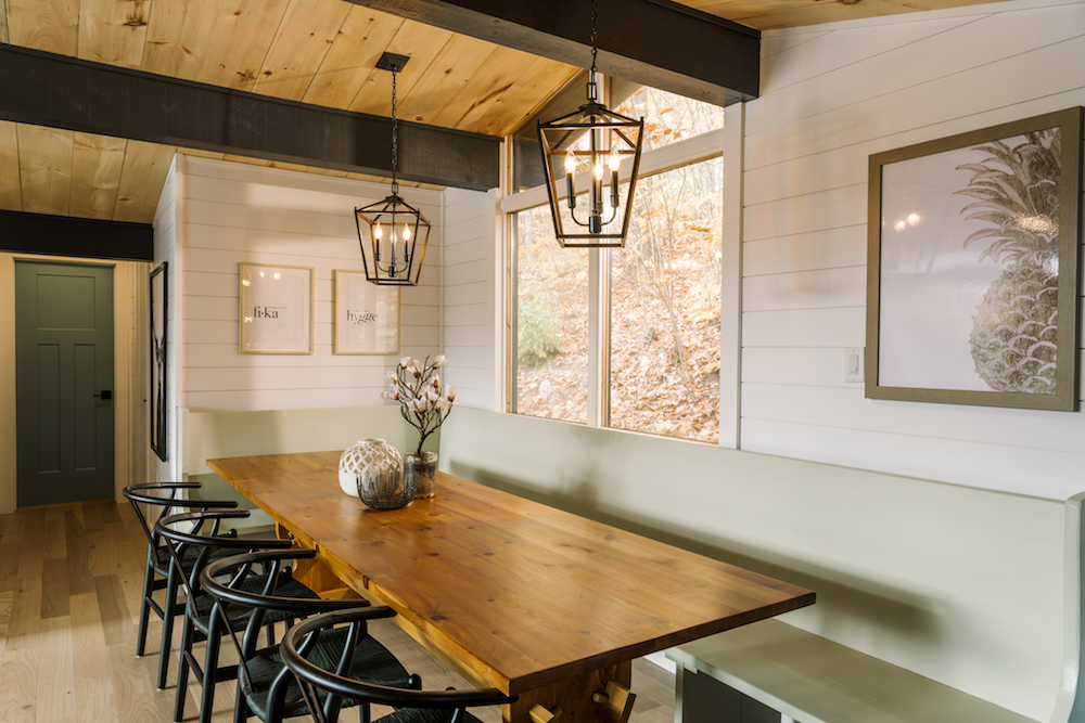 white cottage dining room with green bench and table