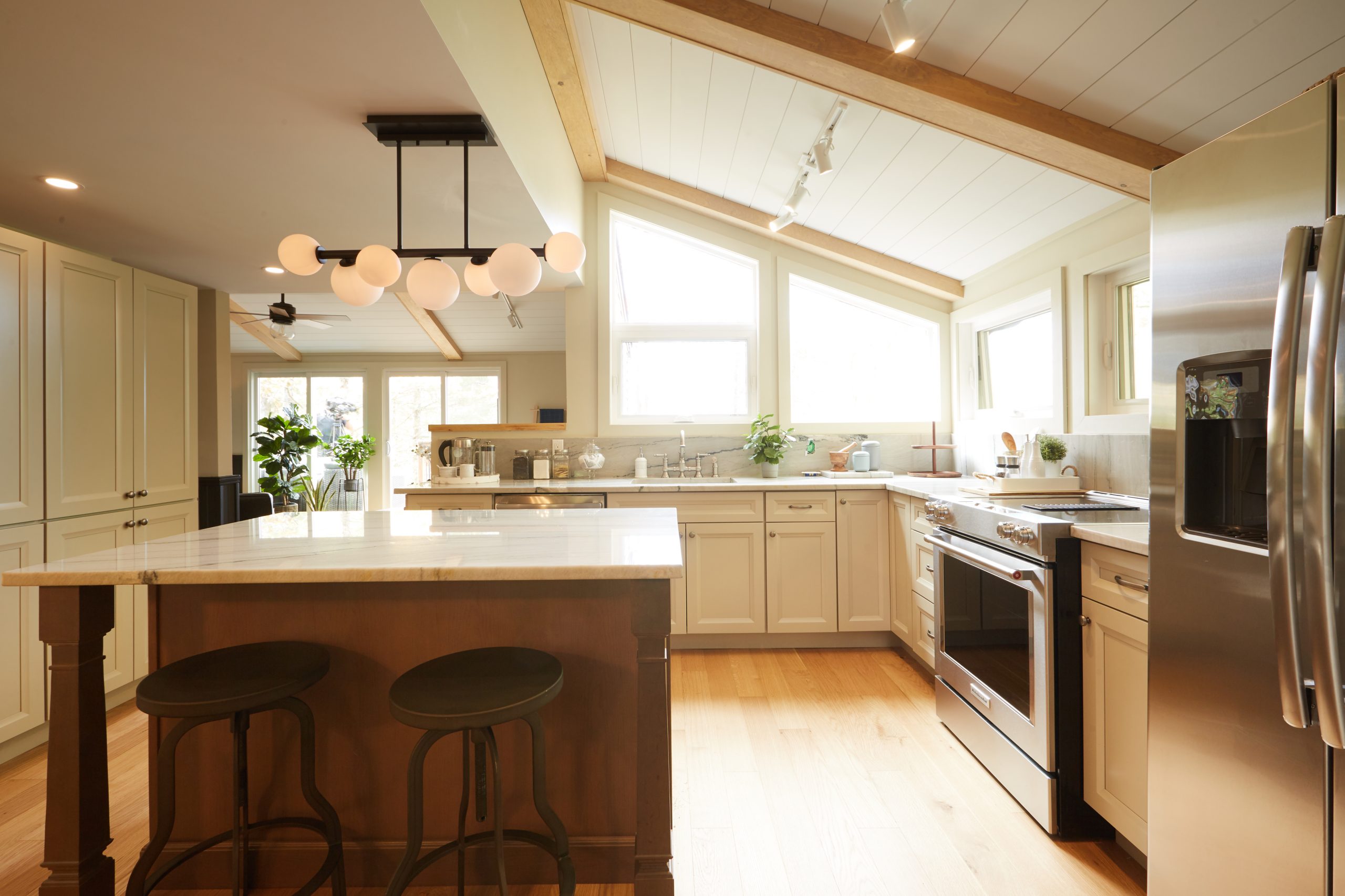 white and wood kitchen with centre island and stainless steel appliances