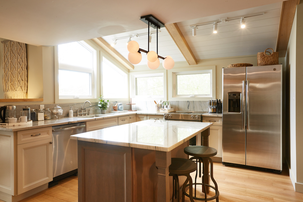 white and wood kitchen with centre island and stainless steel appliances