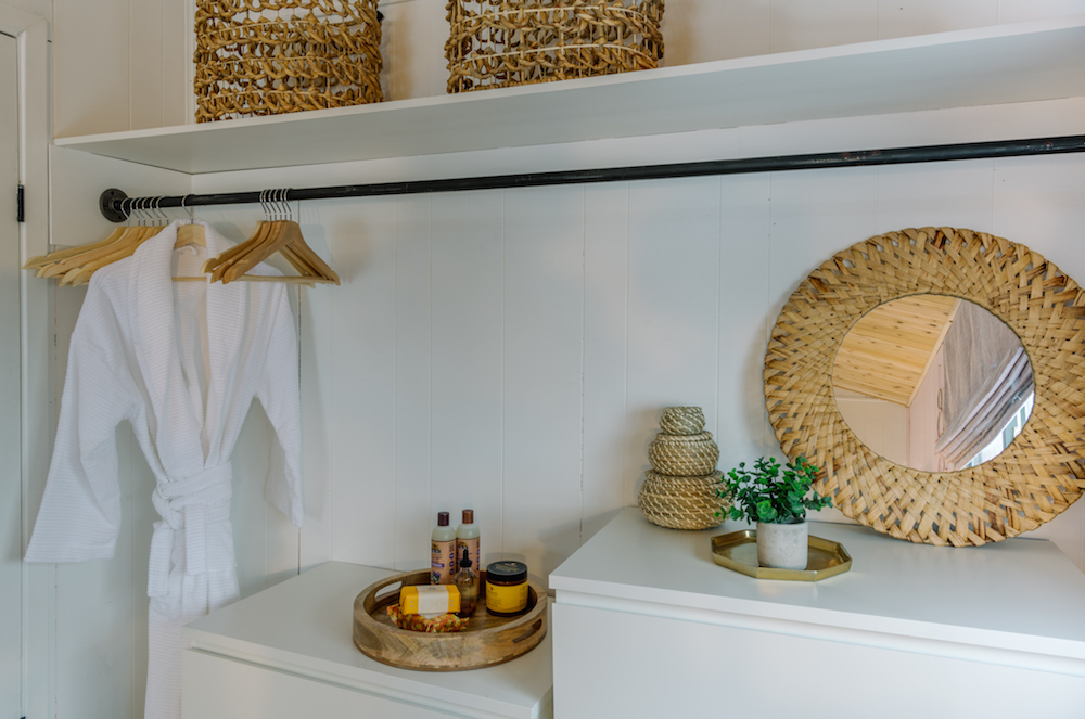 white open closet with hangers and toiletries