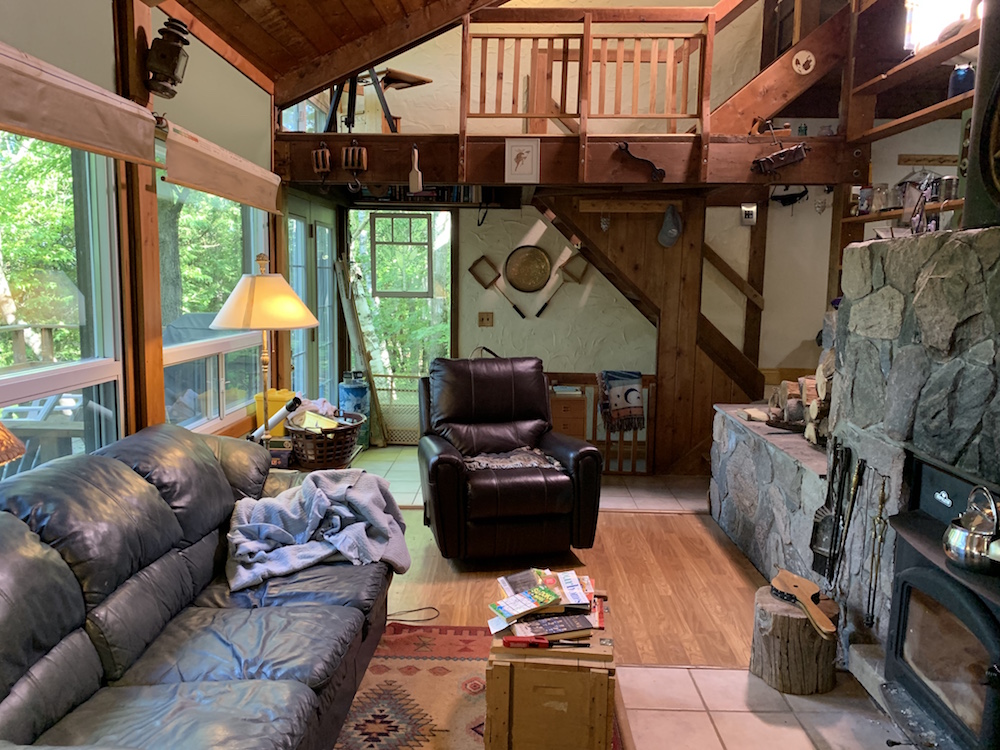 chalet living room with wood accents and old leather couches