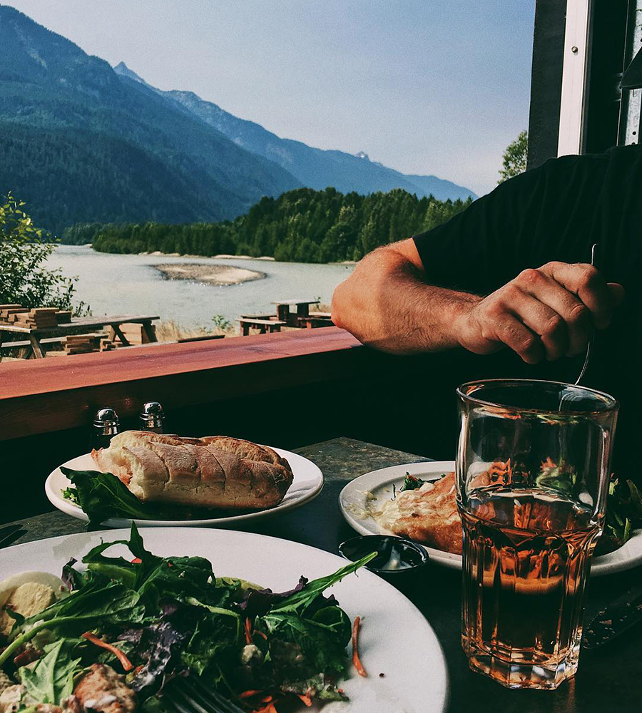 A man eating at a restuarant called The Watershed Grill