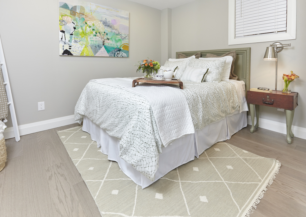 Grey flooring in decorated basement bedroom