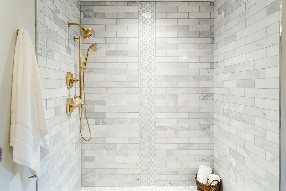 Glass shower with grey subway tile