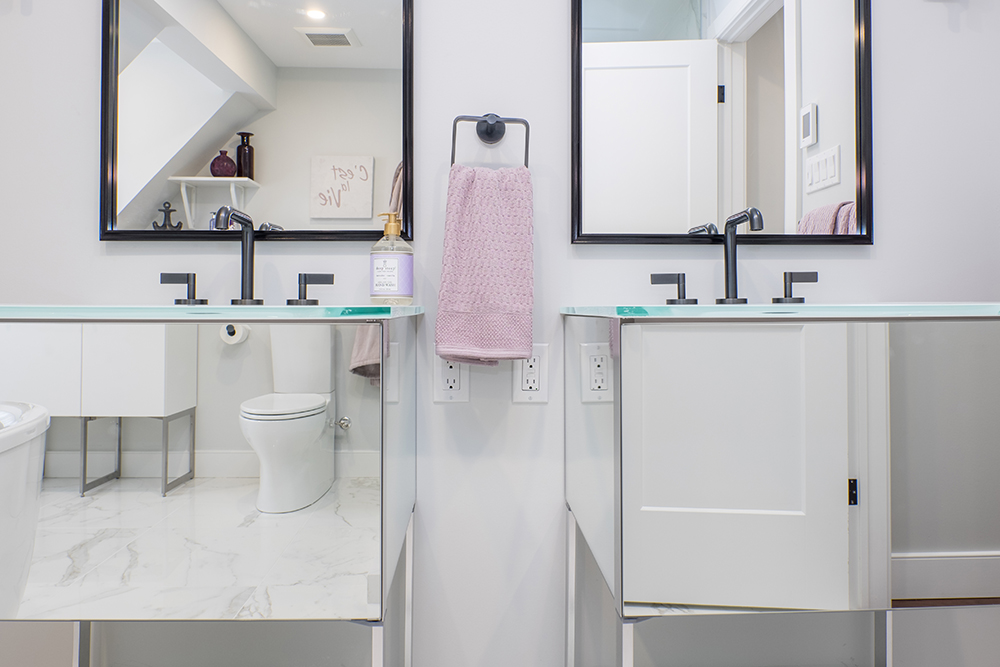 Double vanities with mirrors above and on vanity