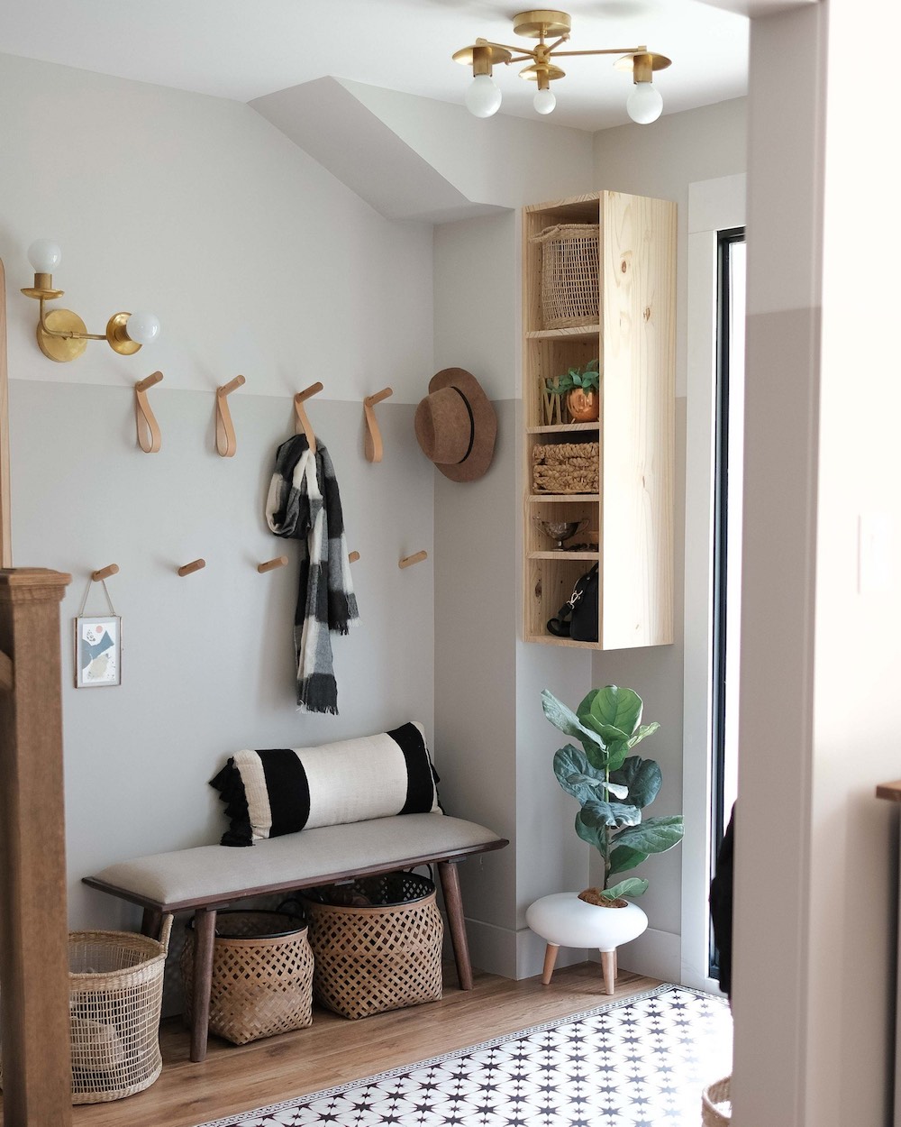 Small foyer with a bench and hooks