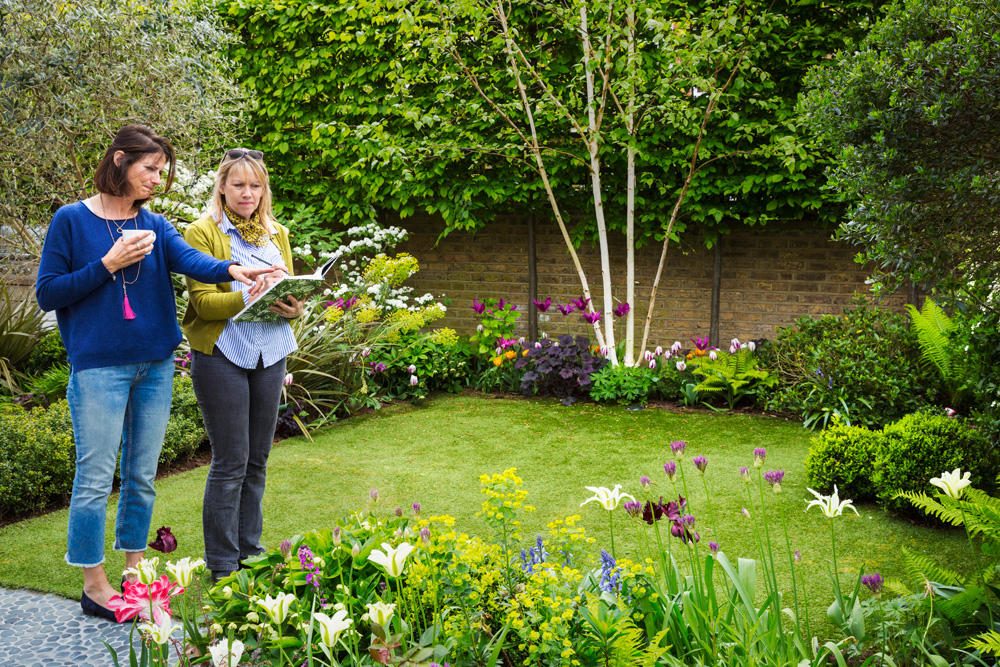 Landscaper and client in yard