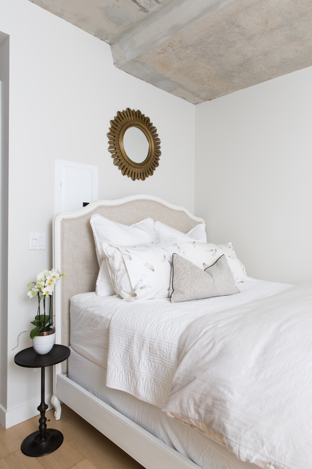 Upholstered headboard and black side table