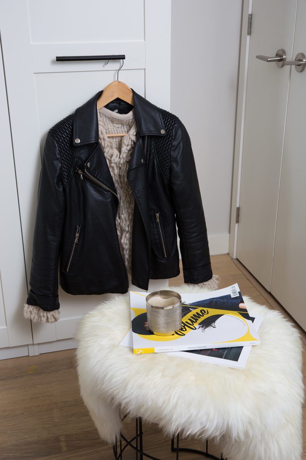 Small stool in entryway topped with sheepskin