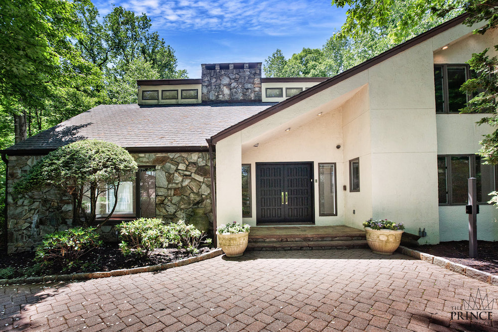 white house exterior with red brick driveway