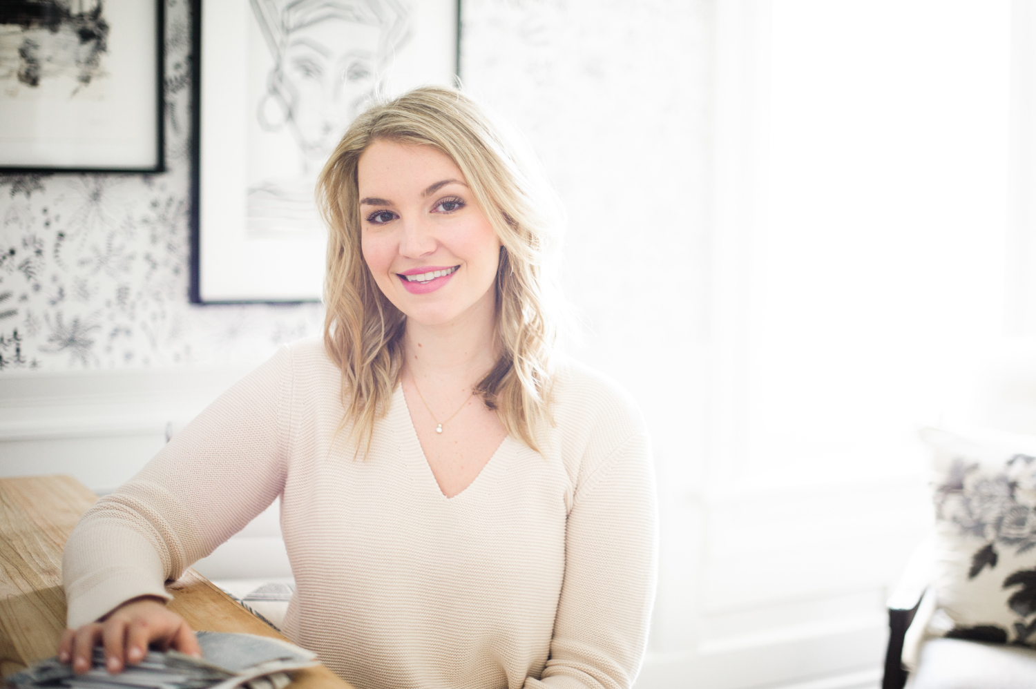 Interior designer Jacquelyn Clark seated at her desk