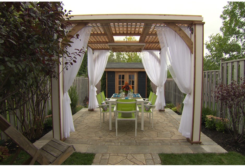 A lattice-top pergola with white transparent canopies and patio furniture