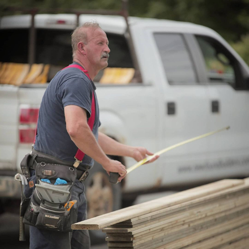 Al measuring on a job site