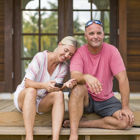 Sarah and Bryan Baeumler on the steps of their Bahamian resort