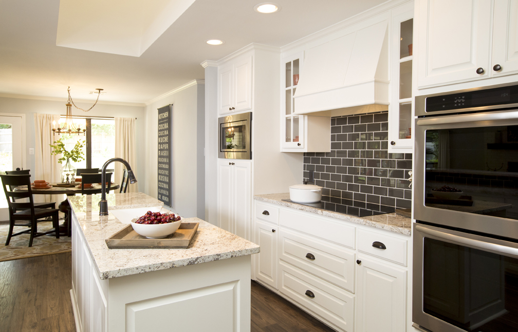 In this kitchen by Joanna Gaines, a patch of black subway tile gives emphasis to the cabinetry.