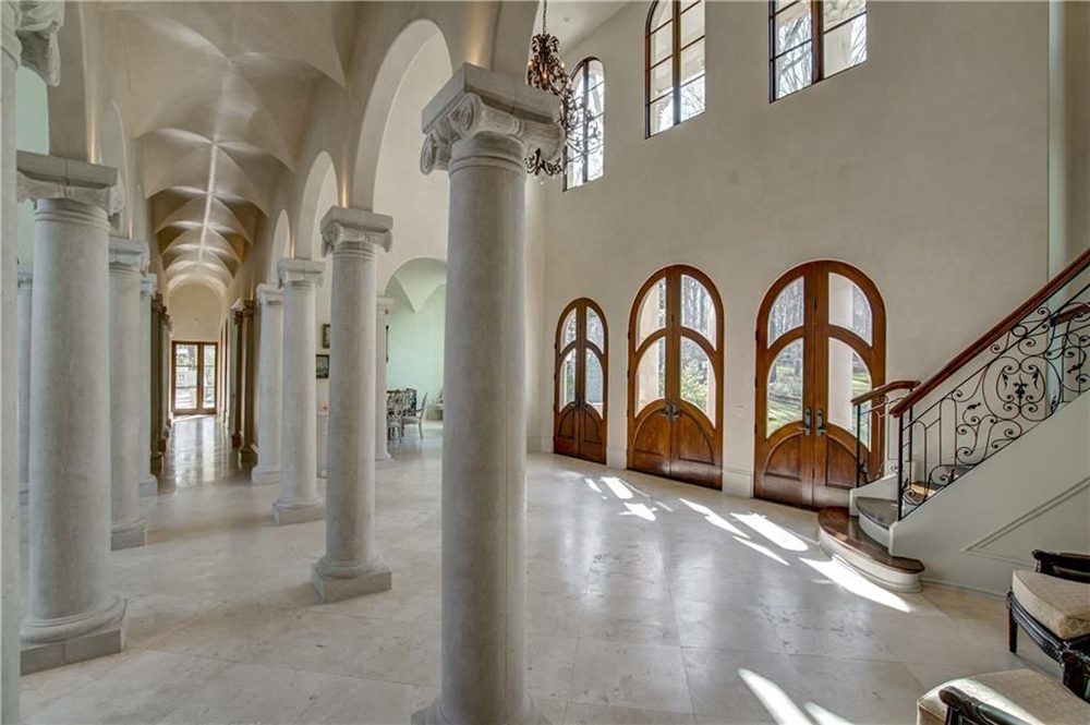 Another angle of the front foyer featuring Corinthian columns