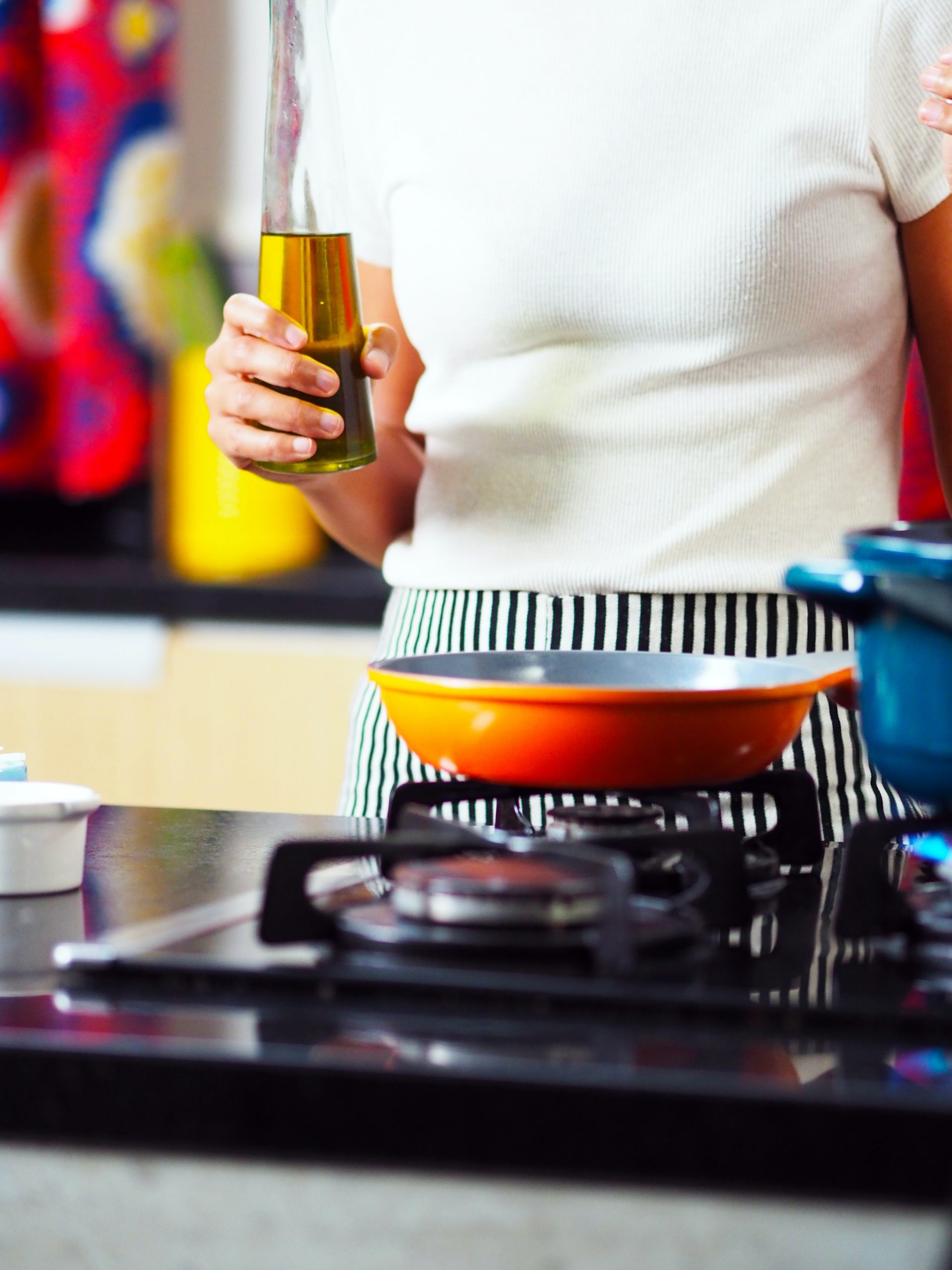 Woman cooking with oil