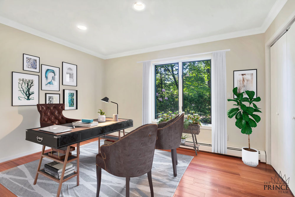 A minimalist home office with a rectangular desk, leather chairs and houseplants