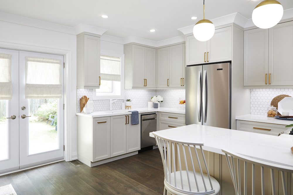 light grey cabinets with gleaming metallic hardware in modern kitchen