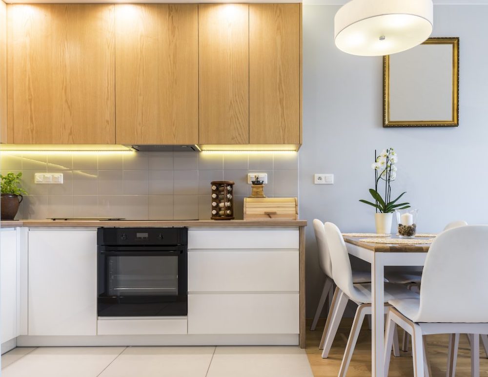 contemporary kitchen with handless-free wood upper cabinets and white lower cabinets