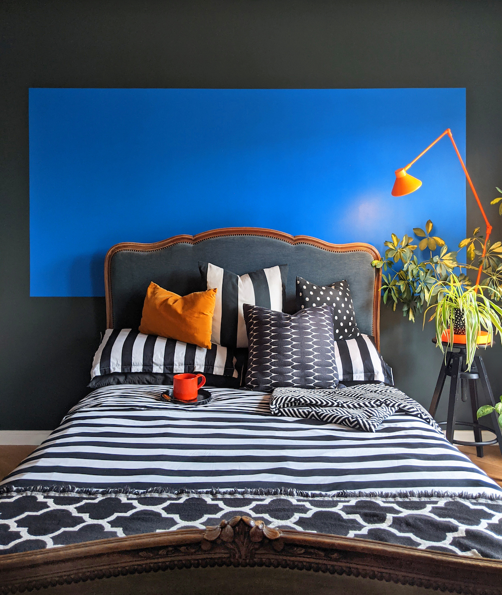 Blue-painted headboard in bedroom