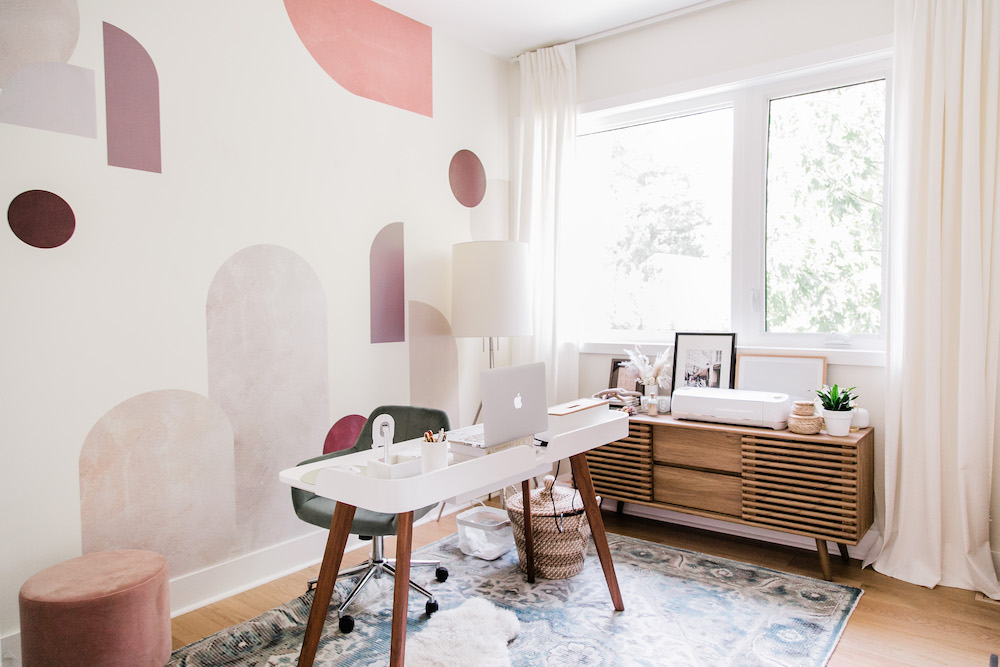 spacious home office with white curtains on window