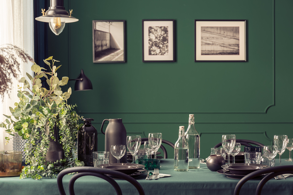 close up of dining area with matte green painted walls