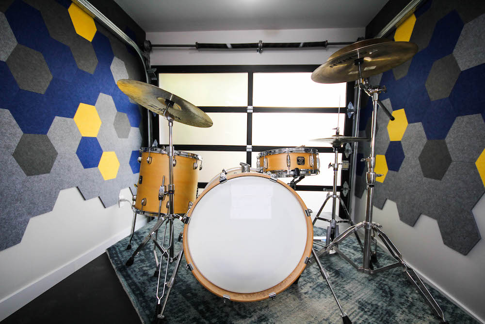 drums in music room with dark-and-light patterned soundproofing walls