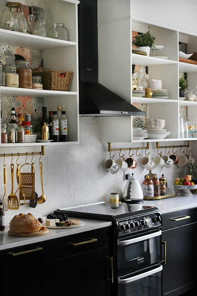 Glam modern kitchen with functional open shelving.