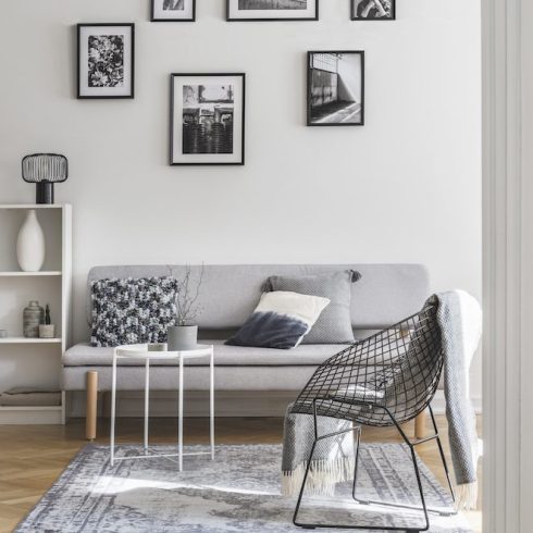 gallery of black and white frames on the wall of living room interior