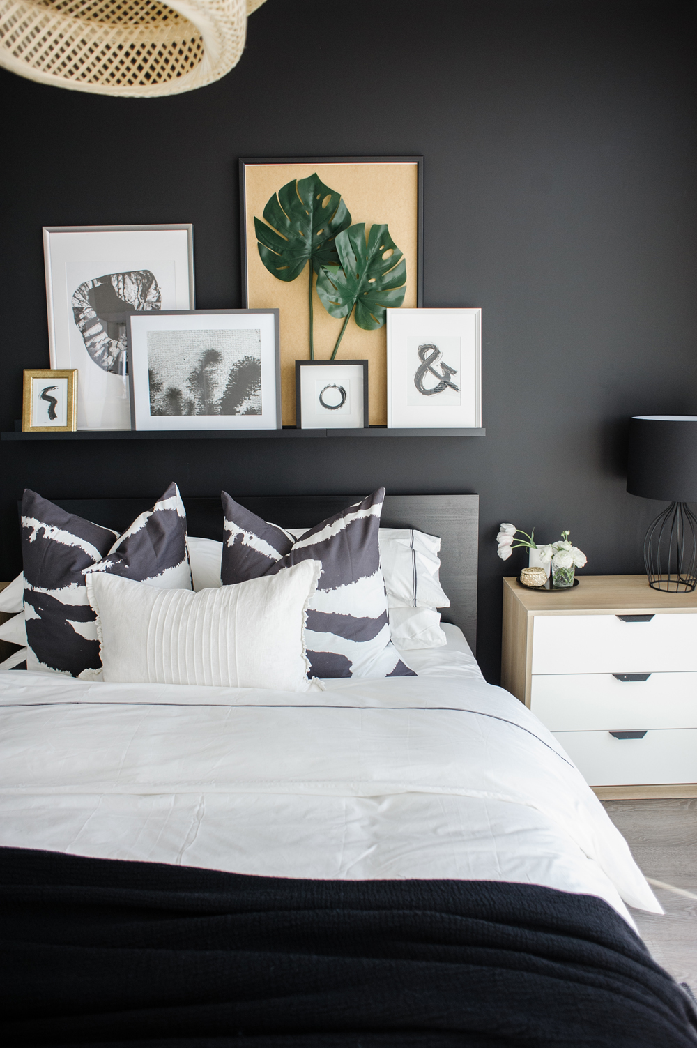 Floating shelf over a bed with artwork