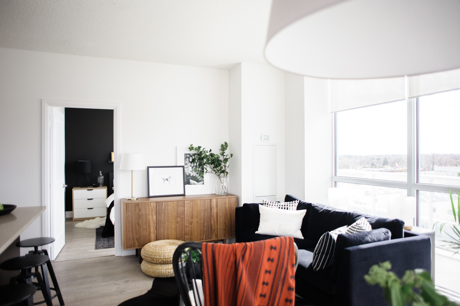 Black and white living room with a red throw