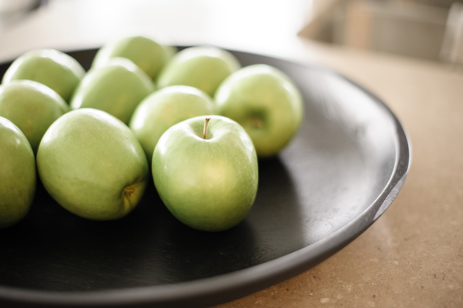 Bowl of bright green apples