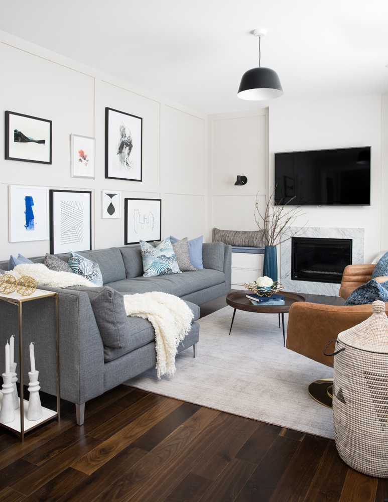 Grey living room with wall moulding and stylish gallery wall.