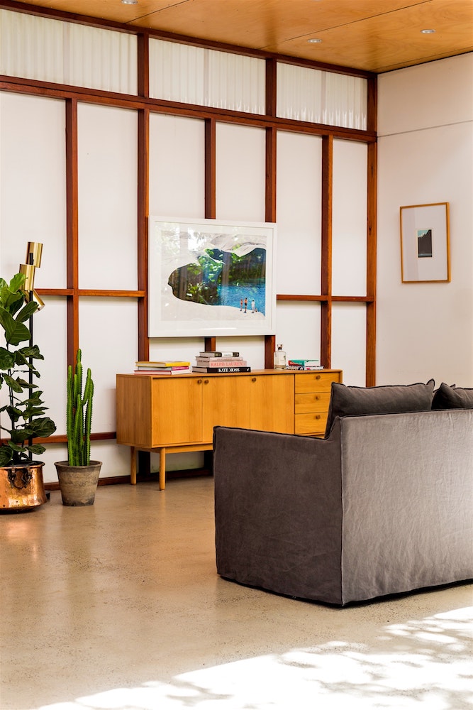 living room with white-and-wood wall panelling behind television