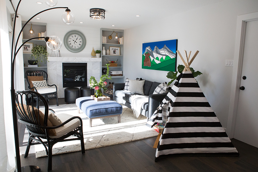 Living room with mountains artwork and kids' play tent