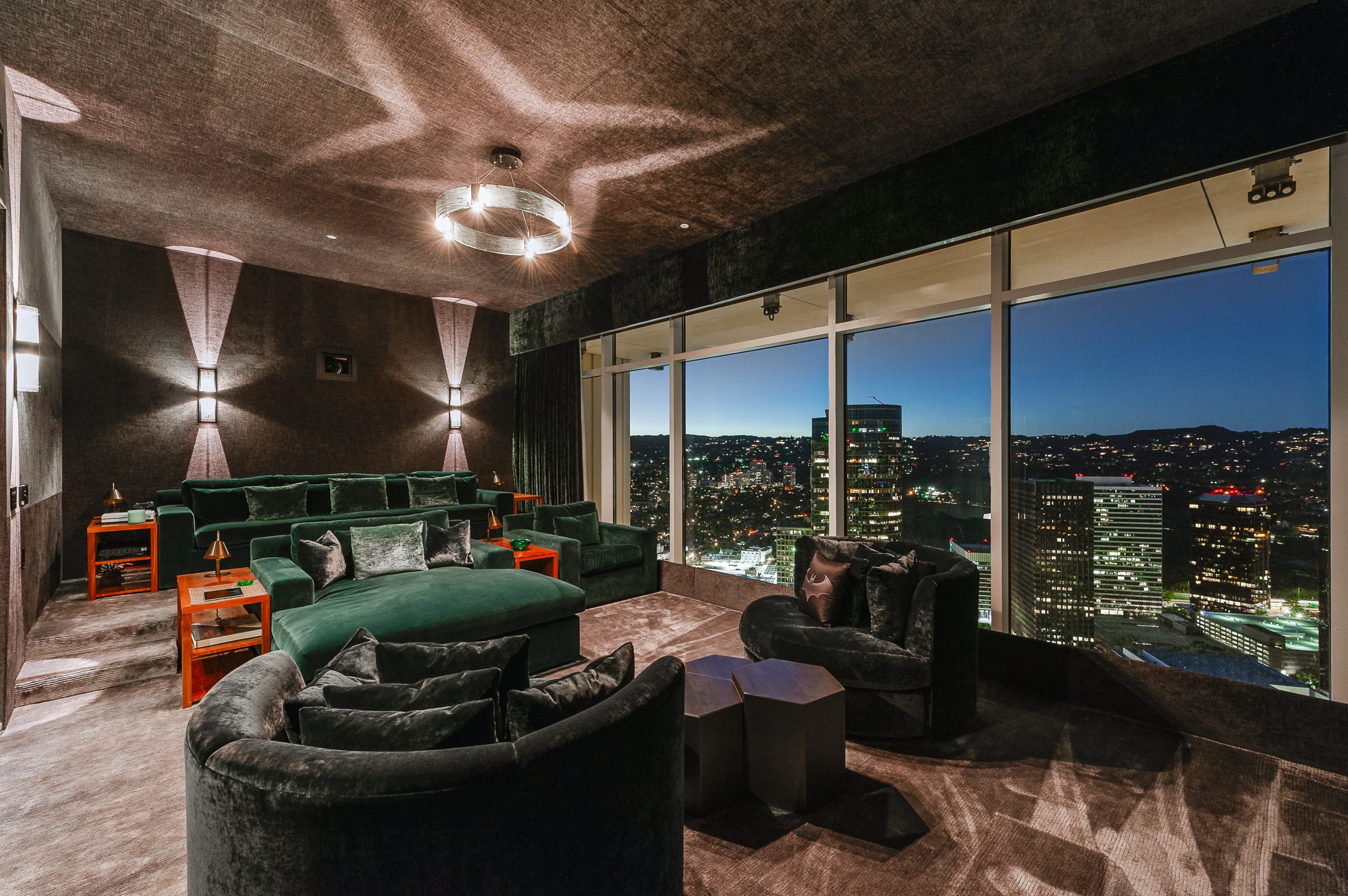 The opposite view of the spacious theatre room that also features floor-to-ceiling windows