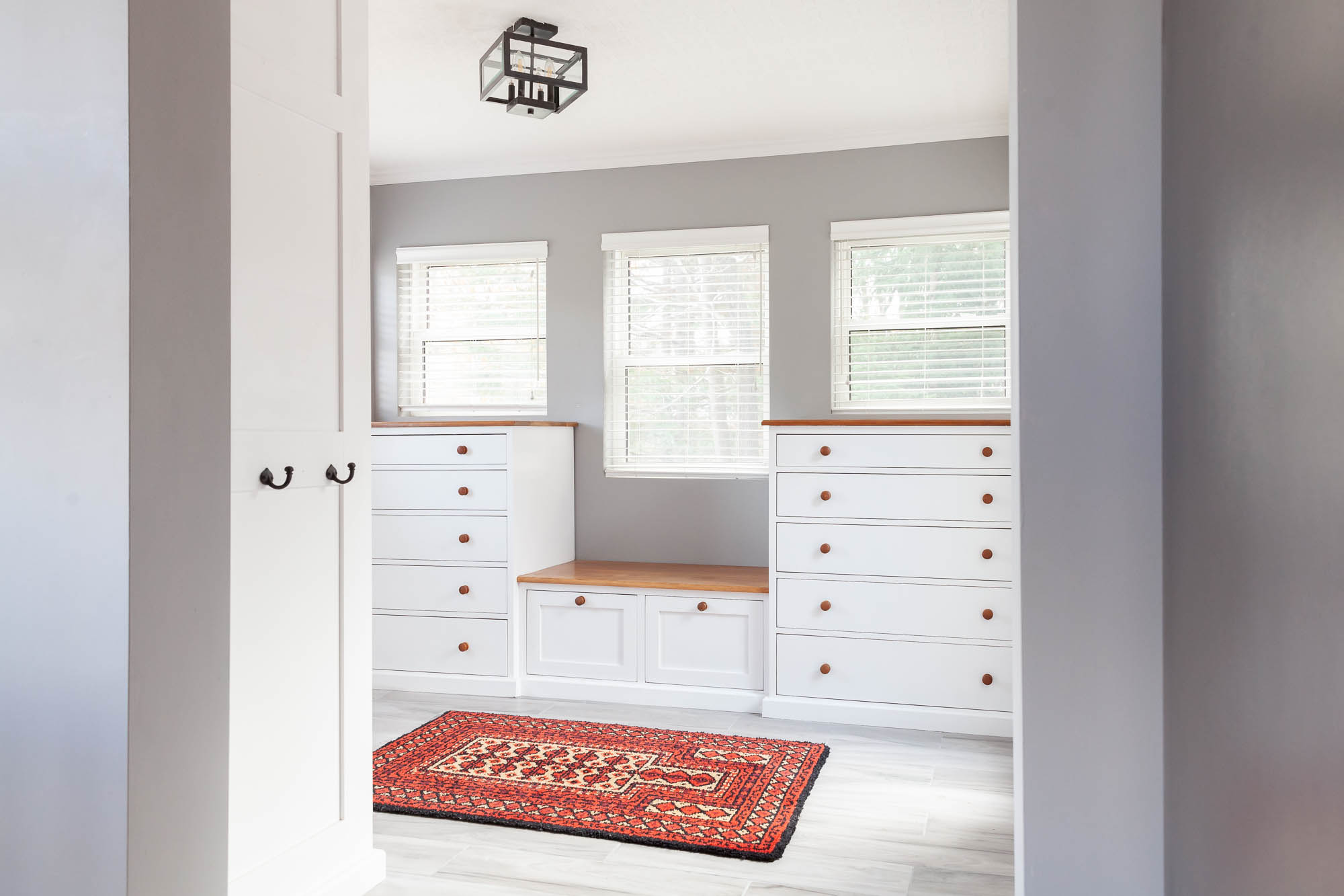 modern white mud room with lots of storage and light