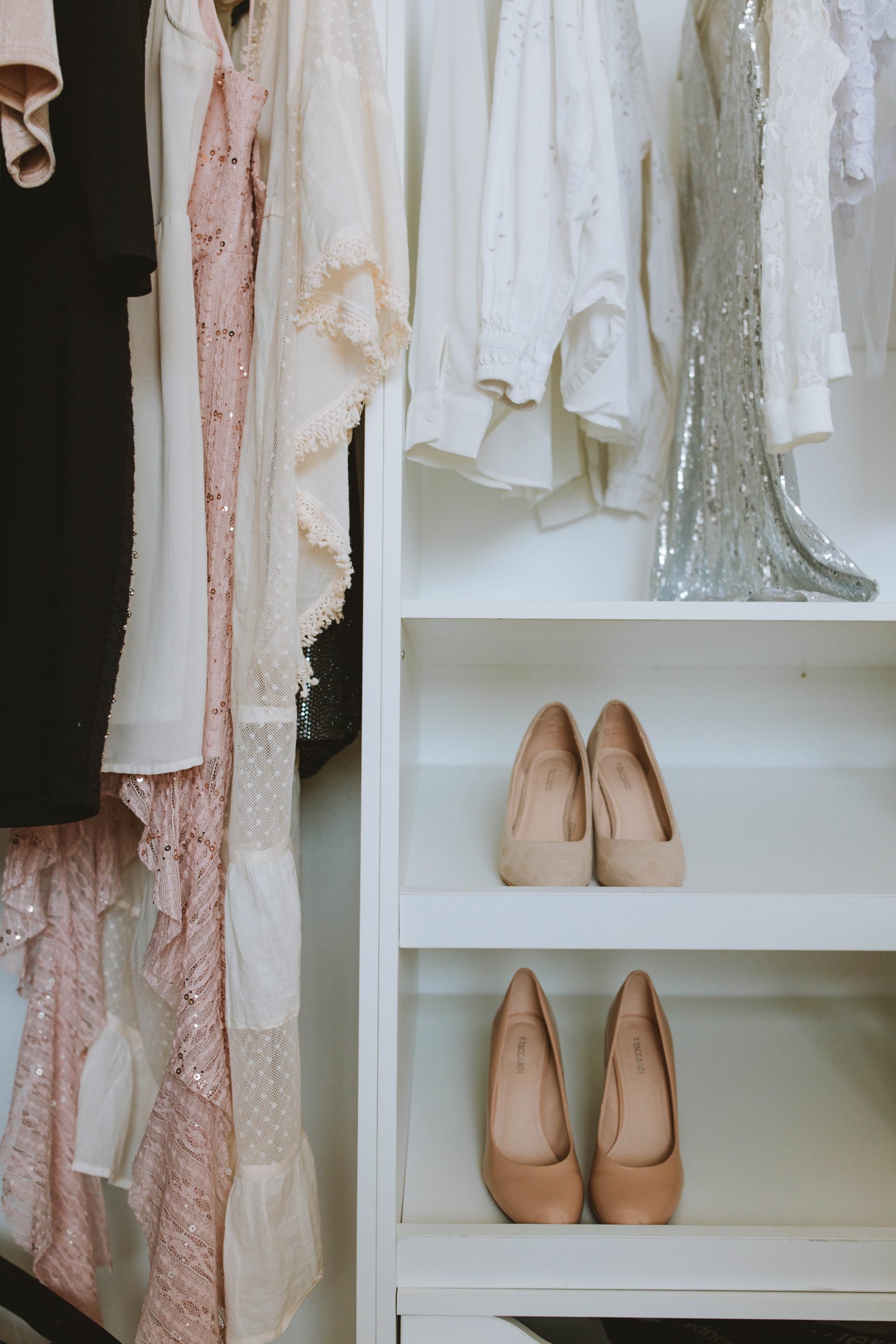 Clothing and shoes hanging in a closet