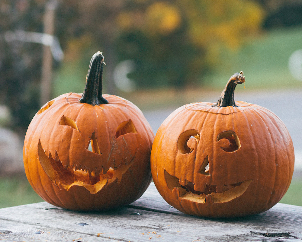 Two Jack-o'-lanterns on a picnic table