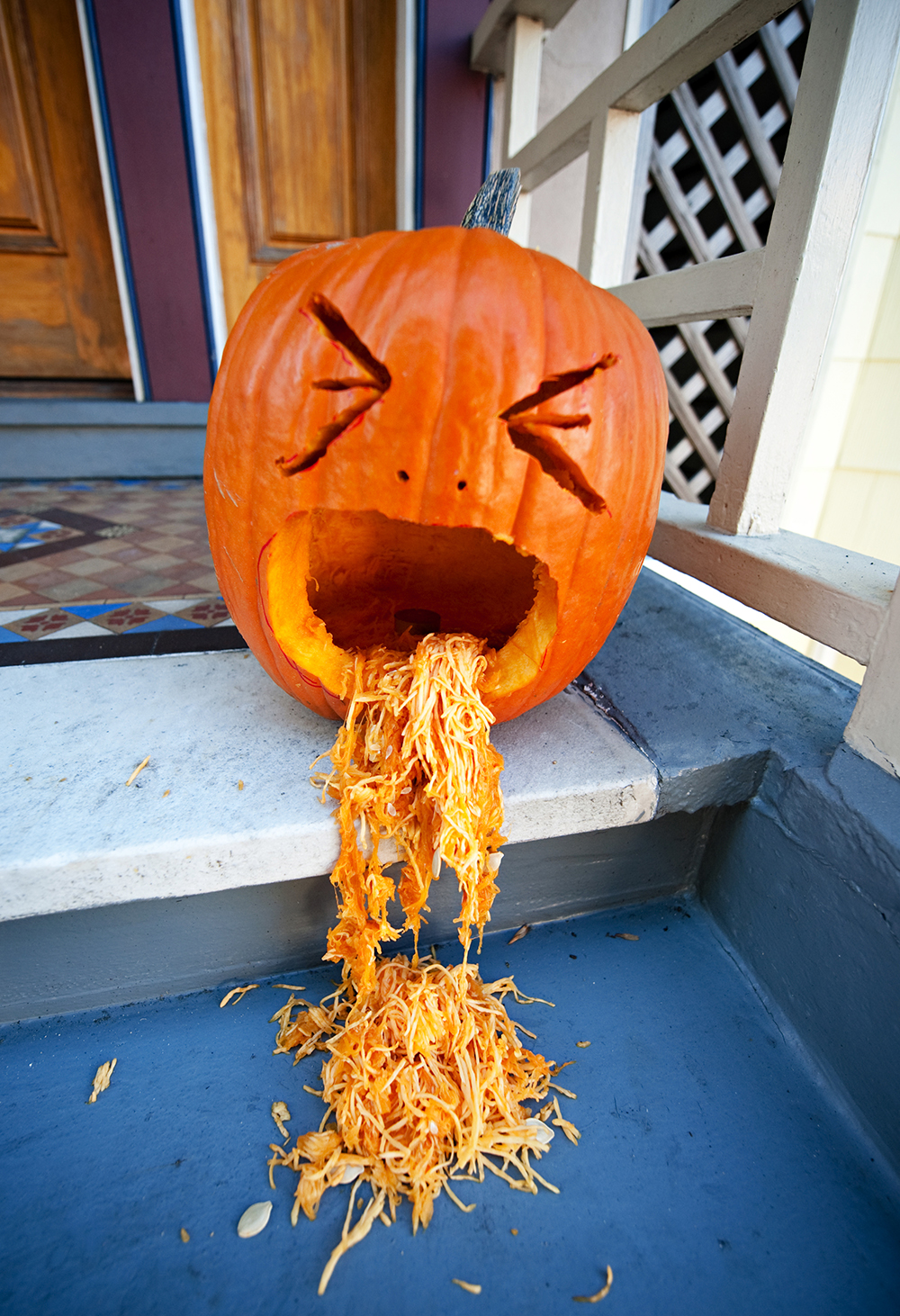 Jack-'o-lantern with pumpkin guts spilling out mouth