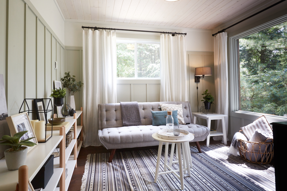 interior of rustic, green flex room with view of forest through windows