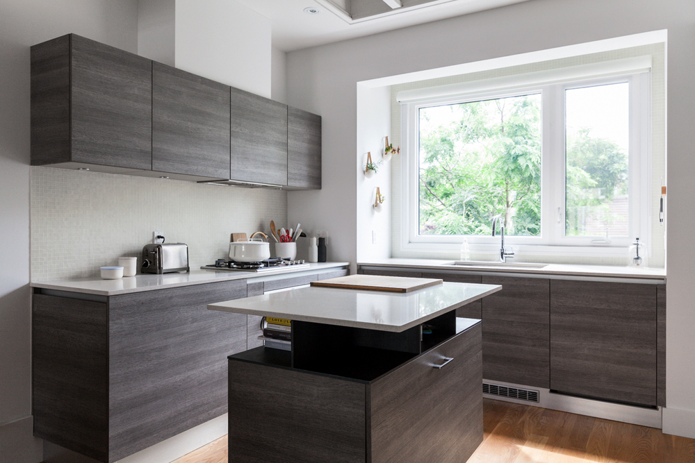 A small kitchen featuring dark wood cabinetry and island