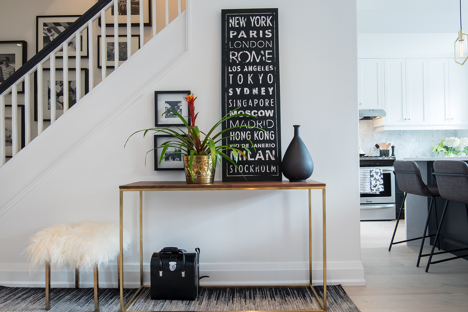 Modern gold, white and black entranceway design.